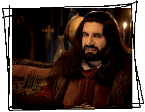 a gif of Nandor the Relentless from what we do in the shadows, looking at the camera and shaking his head.